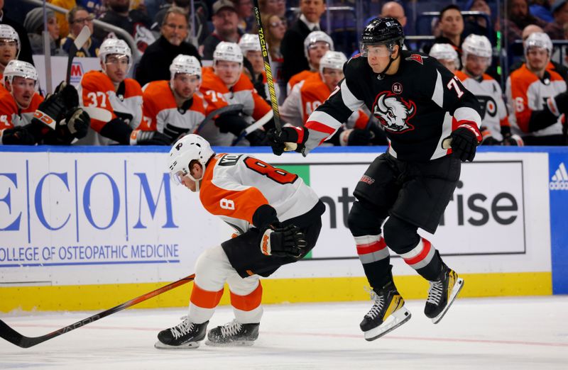 Nov 3, 2023; Buffalo, New York, USA;  Philadelphia Flyers defenseman Cam York (8) tries to check Buffalo Sabres right wing JJ Peterka (77) as he skates up ice during the second period at KeyBank Center. Mandatory Credit: Timothy T. Ludwig-USA TODAY Sports