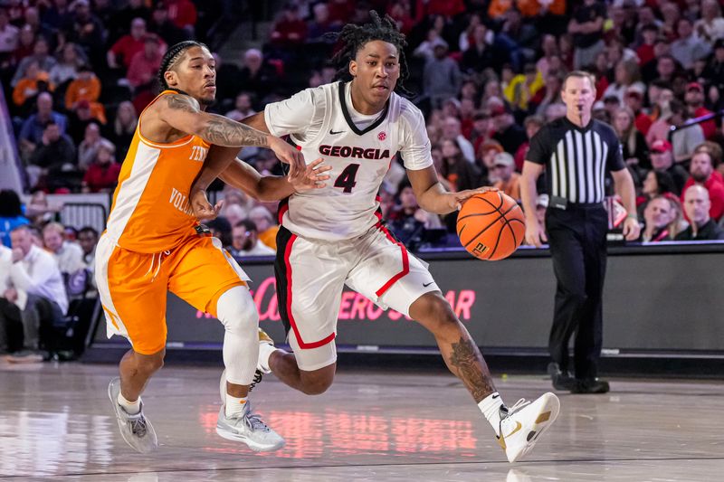 Jan 13, 2024; Athens, Georgia, USA; Georgia Bulldogs guard Silas Demary Jr. (4) dribbles against Tennessee Volunteers guard Zakai Zeigler (5) during the second half at Stegeman Coliseum. Mandatory Credit: Dale Zanine-USA TODAY Sports