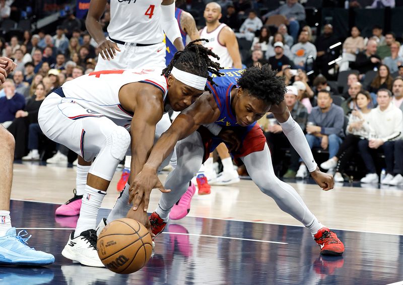 INGLEWOOD, CALIFORNIA - DECEMBER 01: Terance Mann #14 of the LA Clippers reaches for the ball against Peyton Watson #8 of the Denver Nuggets in the first half at Intuit Dome on December 01, 2024 in Inglewood, California.  NOTE TO USER: User expressly acknowledges and agrees that, by downloading and or using this photograph, User is consenting to the terms and conditions of the Getty Images License Agreement. (Photo by Ronald Martinez/Getty Images)