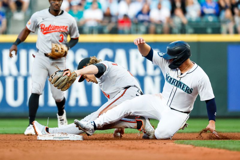 Jul 2, 2024; Seattle, Washington, USA; Baltimore Orioles shortstop Gunnar Henderson (2) makes a force out on Seattle Mariners first baseman Ty France (23) after dropping a throw from a teammate during the sixth inning at T-Mobile Park. France was initially ruled safe but the call as overturned following a review. Mandatory Credit: Joe Nicholson-USA TODAY Sports