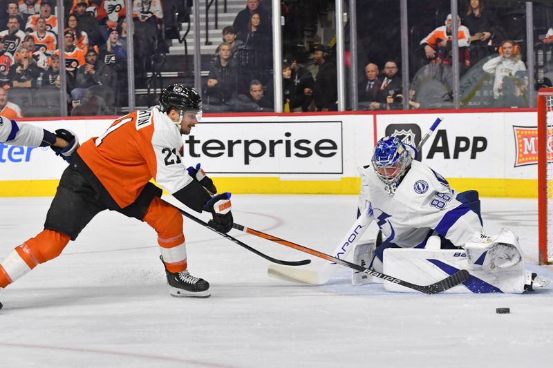 Feb 27, 2024; Philadelphia, Pennsylvania, USA; Philadelphia Flyers center Scott Laughton (21) reaches for the puck against Tampa Bay Lightning goaltender Andrei Vasilevskiy (88) during the first period at Wells Fargo Center. Mandatory Credit: Eric Hartline-USA TODAY Sports