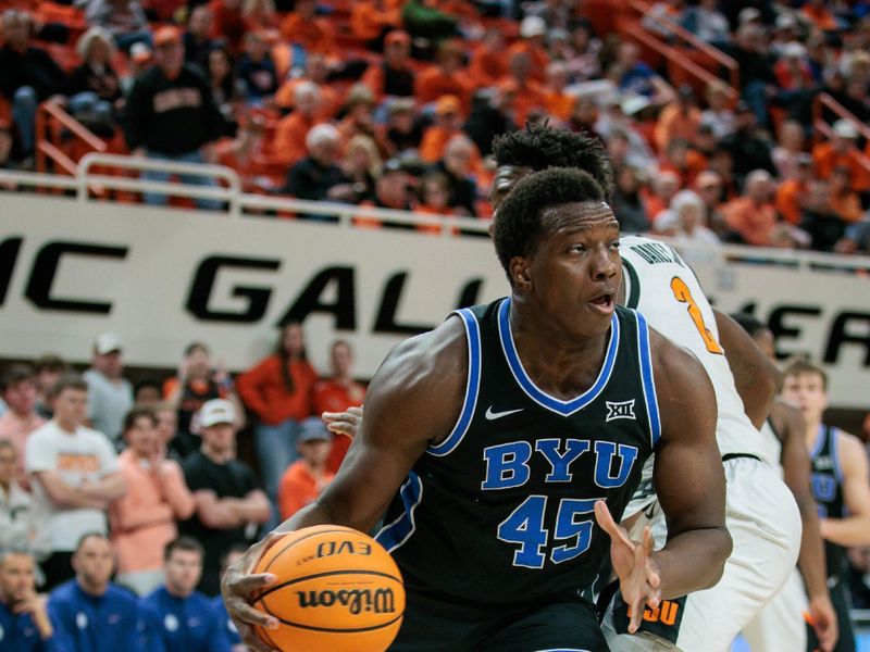 Feb 17, 2024; Stillwater, Oklahoma, USA; Brigham Young Cougars forward Fousseyni Traore (45) drives around Oklahoma State Cowboys forward Eric Dailey Jr. (2) during the second half at Gallagher-Iba Arena. Mandatory Credit: William Purnell-USA TODAY Sports