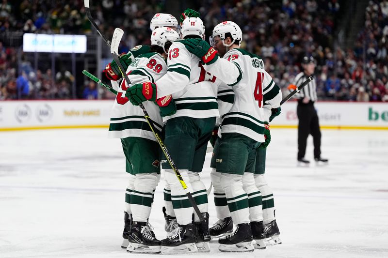 Jan 20, 2025; Denver, Colorado, USA; Minnesota Wild center Yakov Trenin (13) celebrates his goal with center Frederick Gaudreau (89) and defenseman Declan Chisholm (47) in the third period at Ball Arena. Mandatory Credit: Ron Chenoy-Imagn Images