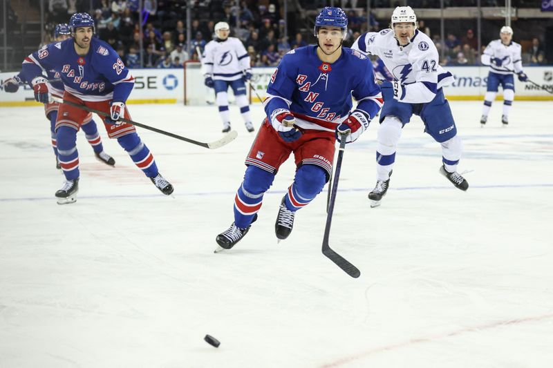 Nov 29, 2025; New York, New York, USA;  New York Rangers defenseman Braden Schneider (4) chases the puck in the first period against the Tampa Bay Lightning at Madison Square Garden. Mandatory Credit: Wendell Cruz-Imagn Images