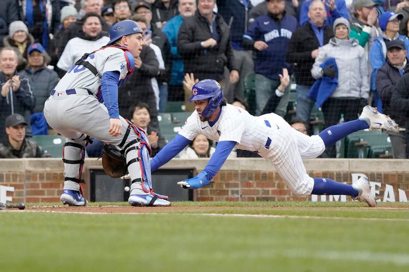 Apr 7, 2024; Chicago, Illinois, USA; Chicago Cubs shortstop Dansby Swanson (7) dives into home plate as Los Angeles Dodgers catcher Will Smith (16) takes a late throw during the first inning at Wrigley Field. Mandatory Credit: David Banks-USA TODAY Sports