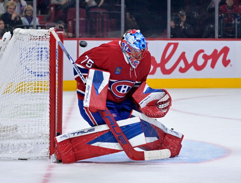 Oct 20, 2025; Montreal, Quebec, CAN; Montreal Canadiens goalie Jakub Dobes (75) makes a save during the second period of the game against the Buffalo Sabres at the Bell Centre. Mandatory Credit: Eric Bolte-Imagn Images