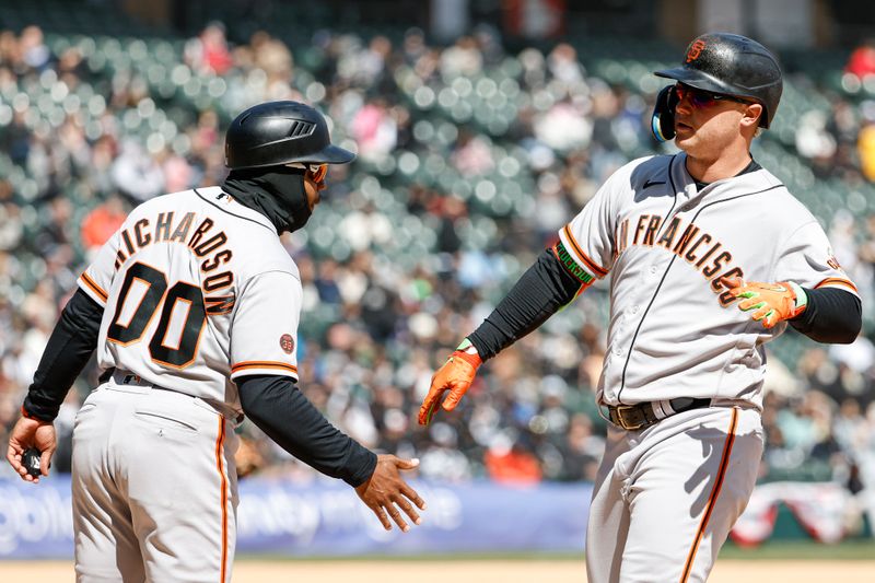 Apr 6, 2023; Chicago, Illinois, USA; San Francisco Giants first baseman Joc Pederson (23) celebrates with first base coach Antoan Richardson (00) after hitting a two-run single against the Chicago White Sox during the fourth inning at Guaranteed Rate Field. Mandatory Credit: Kamil Krzaczynski-USA TODAY Sports