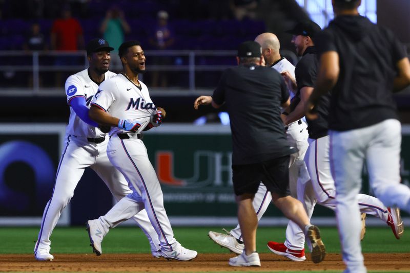 Jun 19, 2024; Miami, Florida, USA; Miami Marlins second baseman Otto Lopez (61) celebrates with teammates after hitting a walk-off single against the St. Louis Cardinals during the ninth inning at loanDepot Park. Mandatory Credit: Sam Navarro-USA TODAY Sports