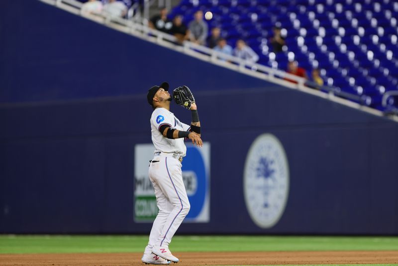 Apr 29, 2024; Miami, Florida, USA; Miami Marlins second baseman Luis Arraez (3) makes a catch to retire Washington Nationals third baseman Trey Lipscomb (not pictured) during the fifth inning at loanDepot Park. Mandatory Credit: Sam Navarro-USA TODAY Sports