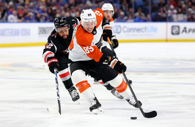 Nov 3, 2023; Buffalo, New York, USA;  Buffalo Sabres left wing Jordan Greenway (12) defends as Philadelphia Flyers right wing Cam Atkinson (89) skates with the puck during the first period at KeyBank Center. Mandatory Credit: Timothy T. Ludwig-USA TODAY Sports