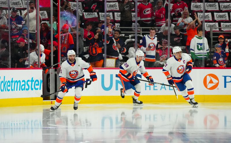 Apr 30, 2024; Raleigh, North Carolina, USA; New York Islanders center Kyle Palmieri (21) left wing Anders Lee (27) and center Brock Nelson (29) skate onto the ice for the warmups against the Carolina Hurricanes in game five of the first round of the 2024 Stanley Cup Playoffs at PNC Arena. Mandatory Credit: James Guillory-USA TODAY Sports