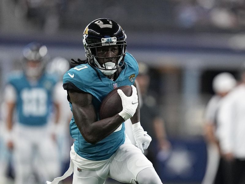 Jacksonville Jaguars wide receiver Calvin Ridley (0) runs the ball during warmups before a presesaon NFL football game against the Dallas Cowboys in Arlington, Texas, Saturday, Aug. 12, 2022. (AP Photo/Tony Gutierrez)