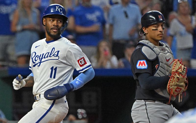 Jun 27, 2024; Kansas City, Missouri, USA;  Kansas City Royals second baseman Maikel Garcia (11) scores a run past Cleveland Guardians catcher Bo Naylor (23) in the sixth inning at Kauffman Stadium. Mandatory Credit: Peter Aiken-USA TODAY Sports