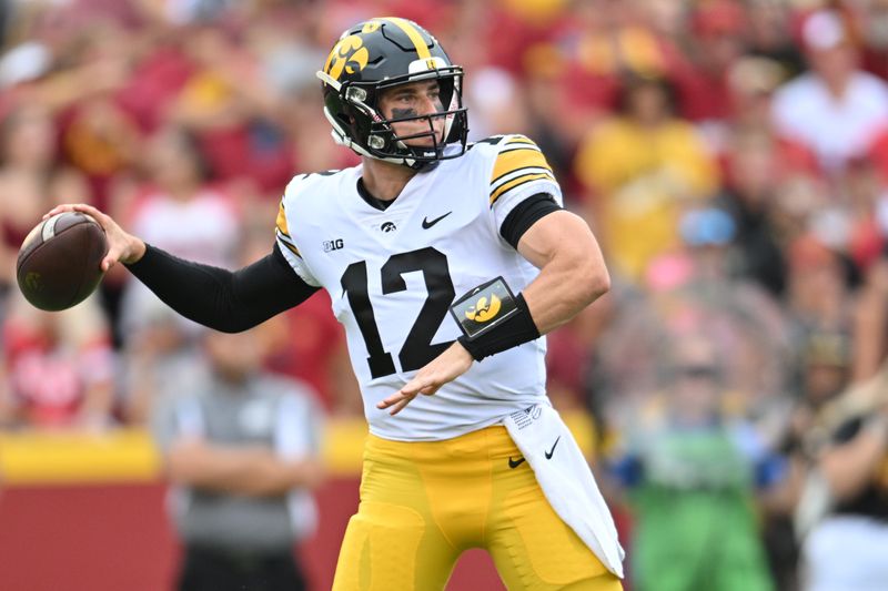 Sep 9, 2023; Ames, Iowa, USA; Iowa Hawkeyes quarterback Cade McNamara (12) looks to throw a pass against the Iowa State Cyclones during the first quarter at Jack Trice Stadium. Mandatory Credit: Jeffrey Becker-USA TODAY Sports