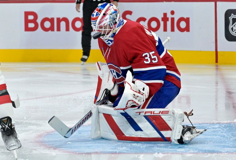 Sep 24, 2024; Montreal, Quebec, CAN; Montreal Canadiens goalie Sam Montembeault (35) makes a save against the New Jersey Devils during the second period at the Bell Centre. Mandatory Credit: Eric Bolte-Imagn Images