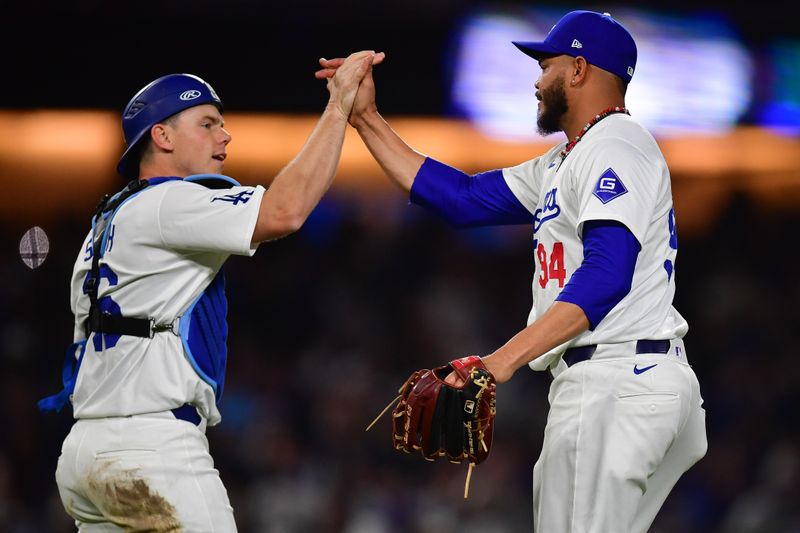 Apr 3, 2024; Los Angeles, California, USA; Los Angeles Dodgers catcher Will Smith (16) and starting pitcher Dinelson Lamet (94) celebrate the victory against the San Francisco Giants at Dodger Stadium. Mandatory Credit: Gary A. Vasquez-USA TODAY Sports