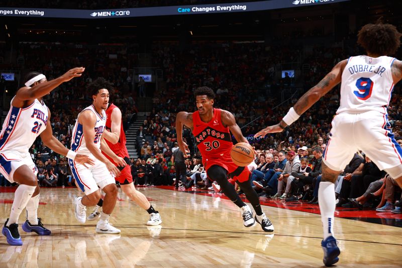 TORONTO, CANADA - OCTOBER 25: Ochai Agbaji #30 of the Toronto Raptors drives to the basket during the game against the Philadelphia 76ers on October 25, 2024 at the Scotiabank Arena in Toronto, Ontario, Canada.  NOTE TO USER: User expressly acknowledges and agrees that, by downloading and or using this Photograph, user is consenting to the terms and conditions of the Getty Images License Agreement.  Mandatory Copyright Notice: Copyright 2024 NBAE (Photo by Vaughn Ridley/NBAE via Getty Images)