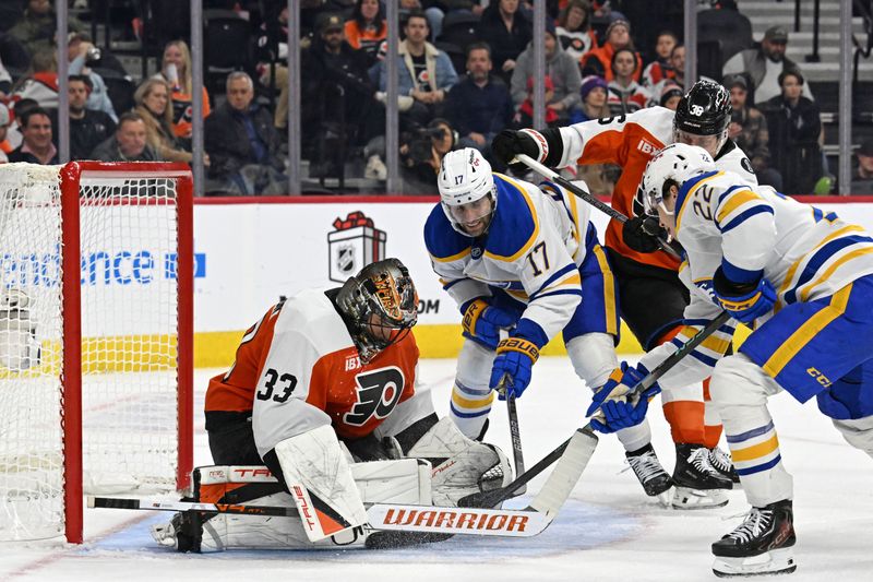 Dec 3, 2025; Philadelphia, Pennsylvania, USA; Philadelphia Flyers goaltender Samuel Ersson (33) makes a save against Buffalo Sabres left wing Jason Zucker (17) and right wing Jack Quinn (22) during the third period at Xfinity Mobile Arena. Mandatory Credit: Eric Hartline-Imagn Images