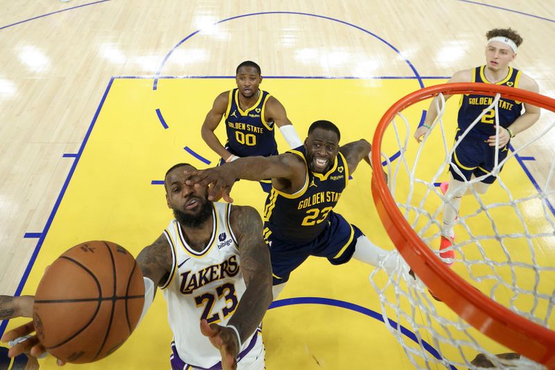 SAN FRANCISCO, CALIFORNIA - JANUARY 27: LeBron James #23 of the Los Angeles Lakers is fouled by Draymond Green #23 of the Golden State Warriors with one second left in double overtime at Chase Center on January 27, 2024 in San Francisco, California. James made both of the free throws and the Lakers won by one point. NOTE TO USER: User expressly acknowledges and agrees that, by downloading and or using this photograph, User is consenting to the terms and conditions of the Getty Images License Agreement.  (Photo by Ezra Shaw/Getty Images)