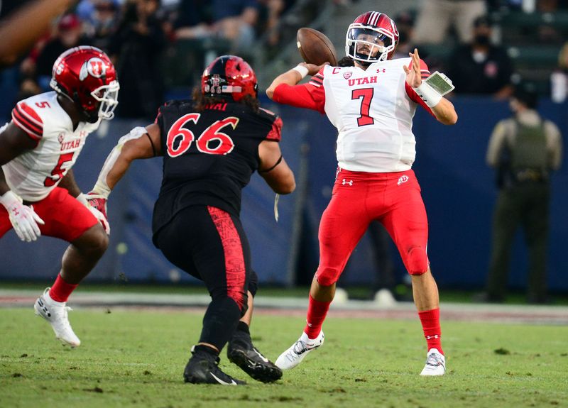 Sep 18, 2021; Carson, California, USA; Utah Utes quarterback Cameron Rising (7) throws as San Diego State Aztecs defensive lineman Jonah Tavai (66) moves in during the second half at Dignity Health Sports Park. Mandatory Credit: Gary A. Vasquez-USA TODAY Sports