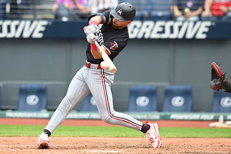 May 1, 2025; Cleveland, Ohio, USA; Minnesota Twins second baseman Edouard Julien (47) hits a single during the seventh inning against the Cleveland Guardians at Progressive Field. Mandatory Credit: Ken Blaze-Imagn Images

