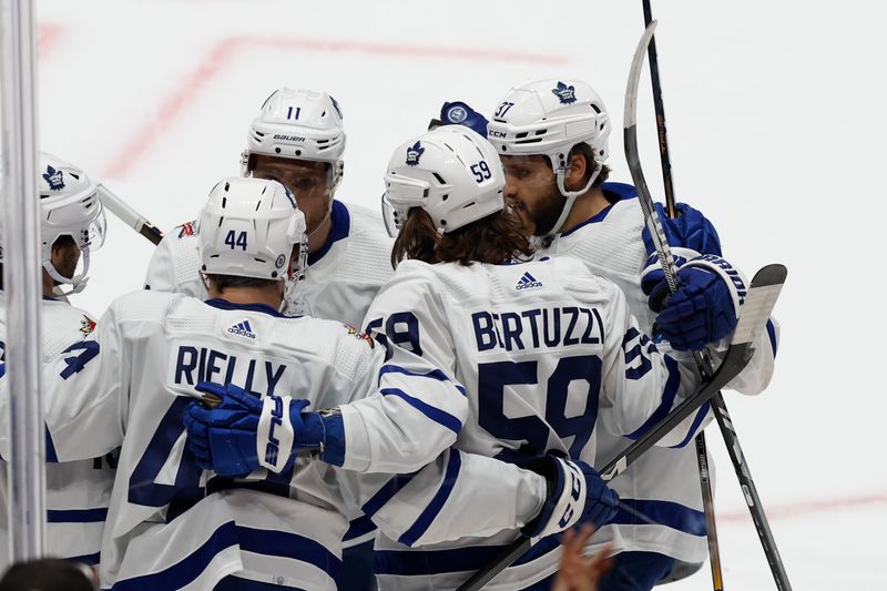 Oct 24, 2023; Washington, District of Columbia, USA; Toronto Maple Leafs defenseman Morgan Rielly (44) celebrates with teammates after scoring a goal against the Washington Capitals in the first period at Capital One Arena. Mandatory Credit: Geoff Burke-USA TODAY Sports