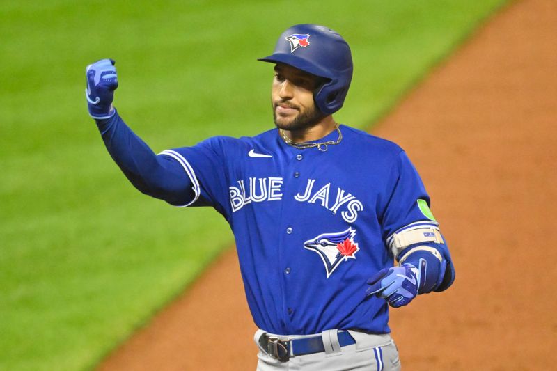 Aug 7, 2023; Cleveland, Ohio, USA; Toronto Blue Jays right fielder George Springer (4) celebrates his RBI single in the ninth inning against the Cleveland Guardians at Progressive Field. Mandatory Credit: David Richard-USA TODAY Sports