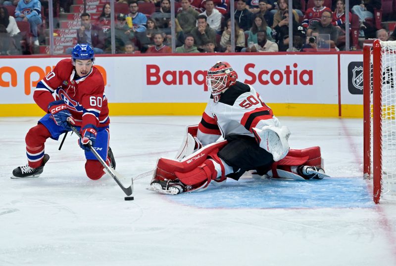 Sep 24, 2024; Montreal, Quebec, CAN; New Jersey Devils goalie Nico Daws (50) stops Montreal Canadiens forward Florian Xhekaj (60) during the third period at the Bell Centre. Mandatory Credit: Eric Bolte-Imagn Images