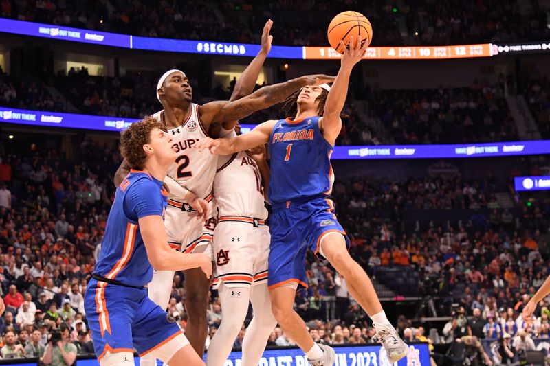 Mar 17, 2024; Nashville, TN, USA; Florida Gators guard Walter Clayton Jr. (1) shoots against Auburn Tigers forward Jaylin Williams (2) in the first half at Bridgestone Arena. Mandatory Credit: Steve Roberts-USA TODAY Sports