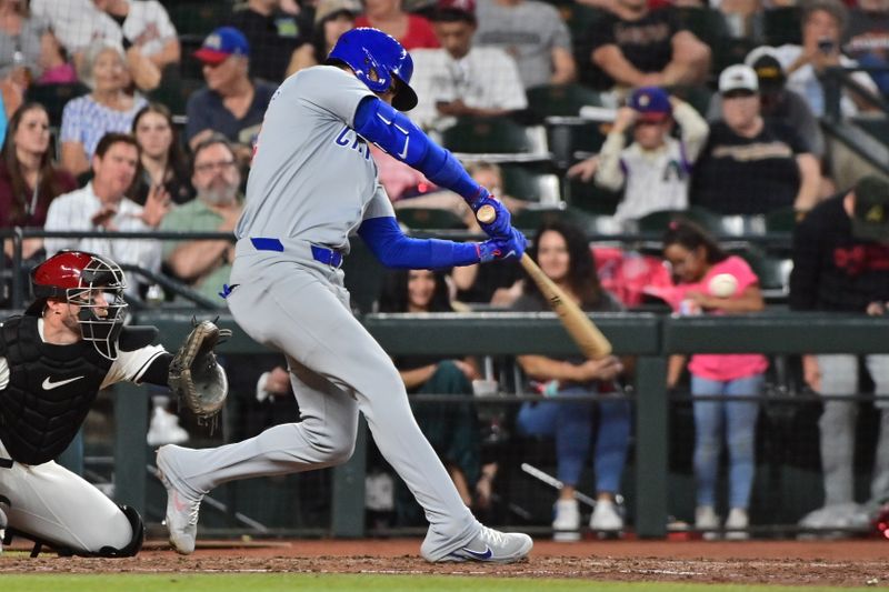 Apr 17, 2024; Phoenix, Arizona, USA;  Chicago Cubs outfielder Cody Bellinger (24) hits a solo home run in the sixth inning against the Arizona Diamondbacks at Chase Field. Mandatory Credit: Matt Kartozian-USA TODAY Sports