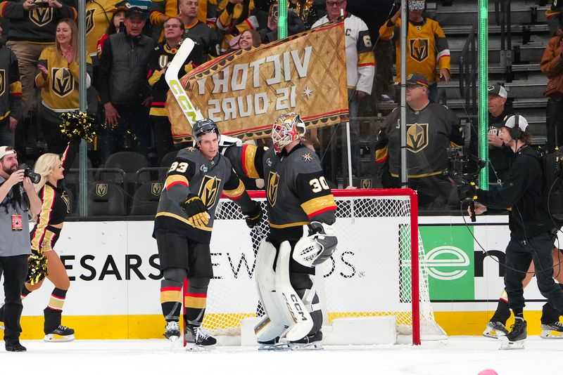 Nov 29, 2025; Las Vegas, Nevada, USA; Vegas Golden Knights right wing Mitch Marner (93) congratulates goaltender Carl Lindbom (30) after the Golden Knights defeated the San Jose Sharks 4-3 at T-Mobile Arena. Mandatory Credit: Stephen R. Sylvanie-Imagn Images