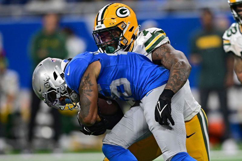 Detroit Lions running back Jahmyr Gibbs is tackle day Green Bay Packers linebacker Quay Walker during the second half of an NFL football game, Thursday, Nov. 23, 2023, in Detroit. The Packers won 29-22. (AP Photo/David Dermer)