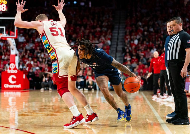 Feb 17, 2024; Lincoln, Nebraska, USA; Penn State Nittany Lions guard Ace Baldwin Jr. (1) drives against Nebraska Cornhuskers forward Rienk Mast (51) during the second half at Pinnacle Bank Arena. Mandatory Credit: Dylan Widger-USA TODAY Sports