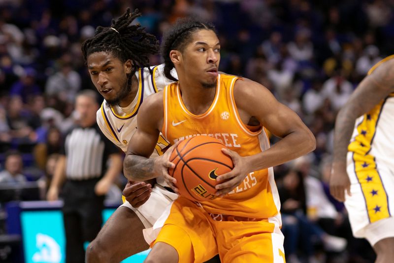 Jan 21, 2023; Baton Rouge, Louisiana, USA;  Tennessee Volunteers guard Zakai Zeigler (5) controls the ball against LSU Tigers guard Justice Williams (11) during the second half at Pete Maravich Assembly Center. Mandatory Credit: Stephen Lew-USA TODAY Sports