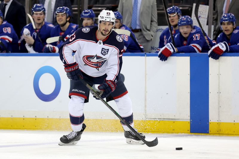 Mar 2, 2026; New York, New York, USA; Columbus Blue Jackets center Sean Monahan (23) plays the puck against the New York Rangers during the third period at Madison Square Garden. Mandatory Credit: Brad Penner-Imagn Images