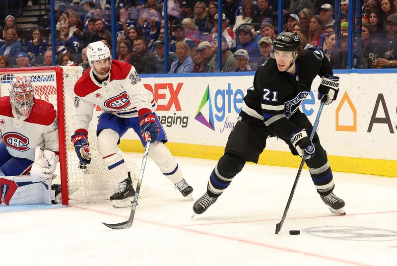 Mar 2, 2024; Tampa, Florida, USA; Tampa Bay Lightning center Brayden Point (21) controls the puck as Montreal Canadiens center Colin White (36) defends during the third period at Amalie Arena. Mandatory Credit: Kim Klement Neitzel-USA TODAY Sports