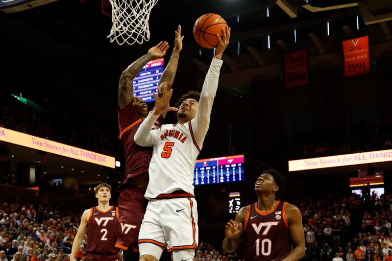 Mar 7, 2026; Charlottesville, Virginia, USA; Virginia Cavaliers guard Sam Lewis (5) shoots the ball as Virginia Tech Hokies forward Tobi Lawal (1) defends in the second half at John Paul Jones Arena. Mandatory Credit: Geoff Burke-Imagn Images