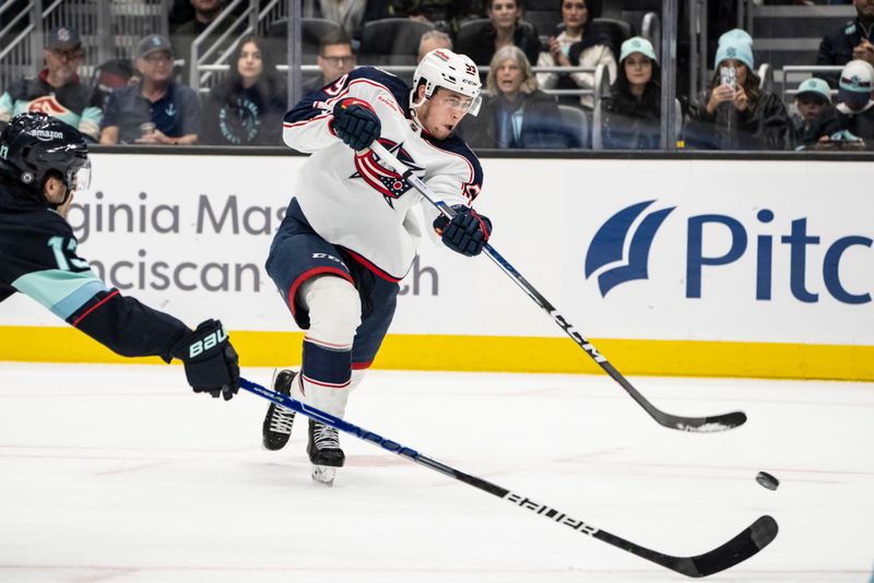 Jan 28, 2024; Seattle, Washington, USA; Columbus Blue Jackets forward Yegor Chinakhov (59) takes a shot against the Seattle Kraken during the third period at Climate Pledge Arena. Mandatory Credit: Stephen Brashear-USA TODAY Sports