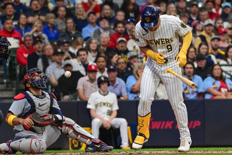 May 11, 2024; Milwaukee, Wisconsin, USA; Milwaukee Brewers left fielder Jake Bauers (9) is hit by a pitch with the bases loaded to force in a run as St. Louis Cardinals catcher Ivan Herrera (48) looks on in the third inning at American Family Field. Mandatory Credit: Benny Sieu-USA TODAY Sports