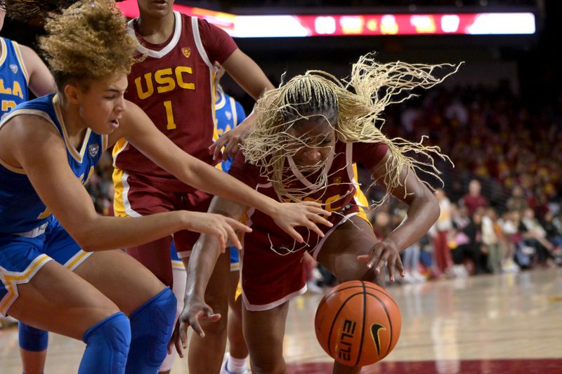 Jan 14, 2024; Los Angeles, California, USA; UCLA Bruins guard Kiki Rice (1) and USC Trojans center Clarice Akunwafo (34) reach for a loose ball in the second half at Galen Center. Mandatory Credit: Jayne Kamin-Oncea-USA TODAY Sports