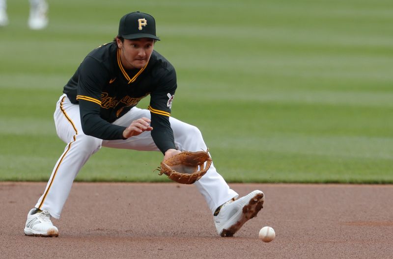 Apr 25, 2024; Pittsburgh, Pennsylvania, USA;  Pittsburgh Pirates second baseman Alika Williams (25) fields a ground ball for an out against Milwaukee Brewers first baseman Jake Bauers (not pictured) during the first inning at PNC Park. Mandatory Credit: Charles LeClaire-USA TODAY Sports