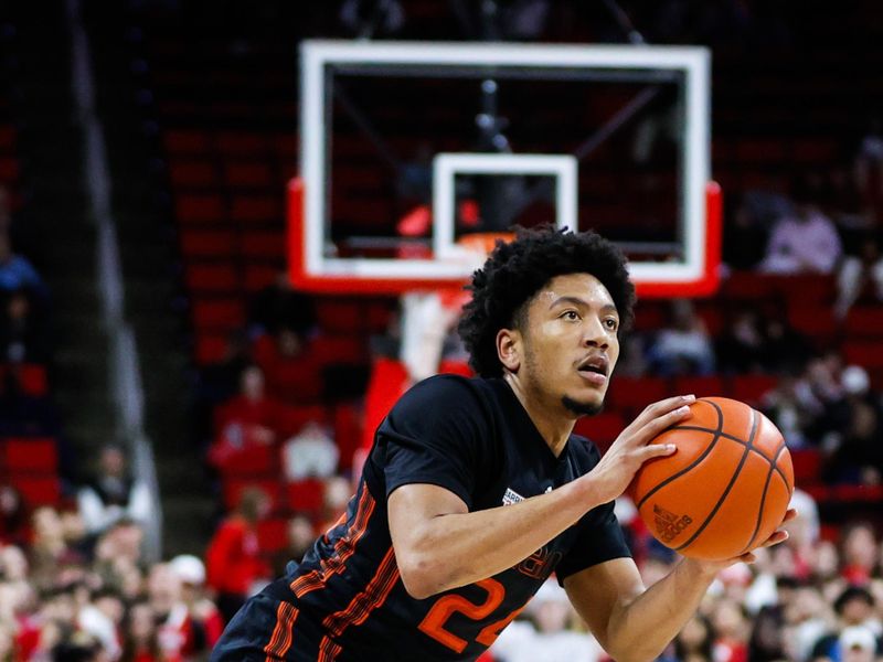 Jan 30, 2024; Raleigh, North Carolina, USA; Miami (Fl) Hurricanes guard Nijel Pack (24) shoots a three pointer  during the second half against North Carolina State Wolfpack at PNC Arena. Mandatory Credit: Jaylynn Nash-USA TODAY Sports