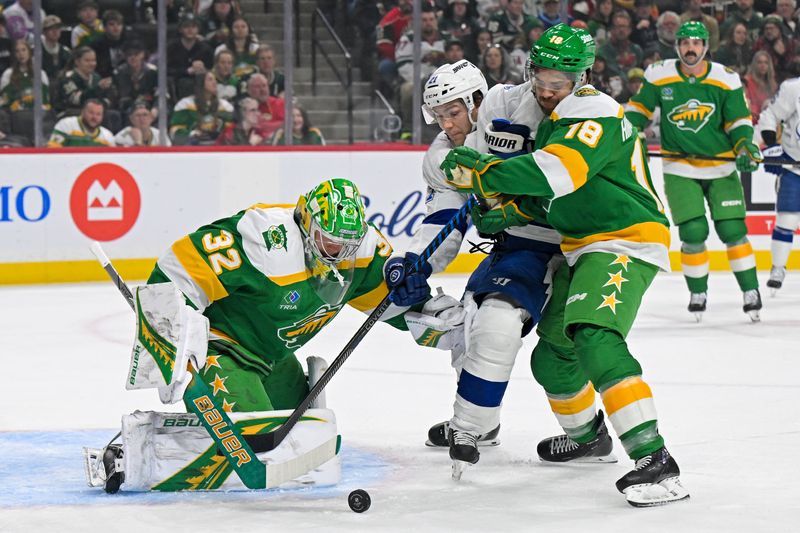 Mar 3, 2026; Saint Paul, Minnesota, USA; Minnesota Wild goalie Filip Gustavsson (32) makes a save as forward Vinnie Hinostroza (18) ties up Tampa Bay Lightning forward Brayden Point (21) during the first period at Grand Casino Arena. Mandatory Credit: Nick Wosika-Imagn Images