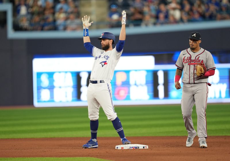 May 12, 2023; Toronto, Ontario, CAN; Toronto Blue Jays designated hitter Brandon Belt (13) celebrates hitting a double against the Atlanta Braves during the seventh inning at Rogers Centre. Mandatory Credit: Nick Turchiaro-USA TODAY Sports