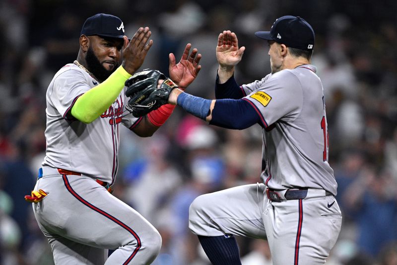 Jul 12, 2024; San Diego, California, USA; Atlanta Braves designated hitter Marcell Ozuna (left) and right fielder Adam Duvall (14) celebrate on the field after defeating the San Diego Padres at Petco Park. Mandatory Credit: Orlando Ramirez-USA TODAY Sports 