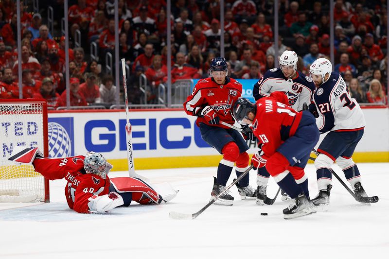 Nov 2, 2024; Washington, District of Columbia, USA; Washington Capitals goaltender Logan Thompson (48) makes a save on Columbus Blue Jackets center Zachary Aston-Reese (27) in the second period at Capital One Arena. Mandatory Credit: Geoff Burke-Imagn Images