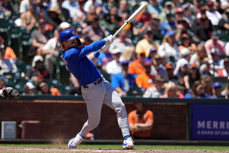 Jun 27, 2024; San Francisco, California, USA; Chicago Cubs second baseman Nico Hoerner (2) hits a single against the San Francisco Giants during the seventh inning at Oracle Park. Mandatory Credit: Darren Yamashita-USA TODAY Sports