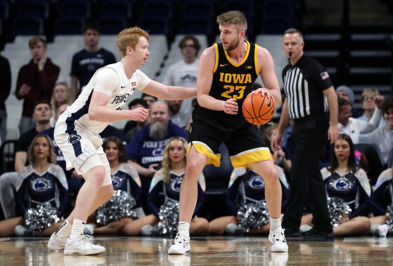 Feb 8, 2024; University Park, Pennsylvania, USA; Iowa Hawkeyes forward Ben Krikke (23) dribbles the ball towards the basket as Penn State Nittany Lions forward Leo O'Boyle (11) during the first half at Bryce Jordan Center. Penn State defeated Iowa 89-79. Mandatory Credit: Matthew O'Haren-USA TODAY Sports