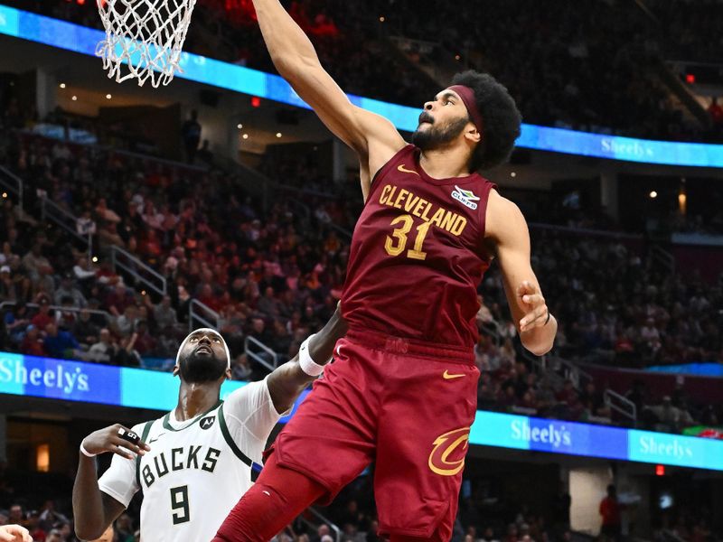 CLEVELAND, OHIO - NOVEMBER 04: Jarrett Allen #31 of the Cleveland Cavaliers dunks over Bobby Portis #9 of the Milwaukee Bucks during the fourth quarter at Rocket Mortgage Fieldhouse on November 04, 2024 in Cleveland, Ohio. The Cavaliers defeated the Bucks 116-114. NOTE TO USER: User expressly acknowledges and agrees that, by downloading and or using this photograph, User is consenting to the terms and conditions of the Getty Images License Agreement. (Photo by Jason Miller/Getty Images)