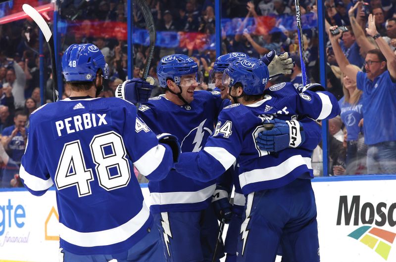 Nov 20, 2023; Tampa, Florida, USA; Tampa Bay Lightning left wing Tanner Jeannot (84) is congratulated by center Tyler Motte (64) after he scored a goal against the Boston Bruins during the first period at Amalie Arena. Mandatory Credit: Kim Klement Neitzel-USA TODAY Sports